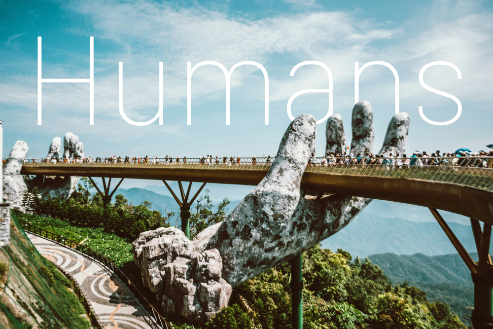 Hand bridge with Humans written in sky